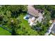 A beautiful aerial view of the home, set on a sprawling lawn with mature trees at 211 60Th S Ave, St Petersburg, FL 33705