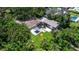 Aerial view of a backyard featuring a modern pergola, a well-maintained lawn, and palm trees at 211 60Th S Ave, St Petersburg, FL 33705