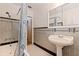 Classic bathroom features a pedestal sink and gray tile with black accents at 211 60Th S Ave, St Petersburg, FL 33705