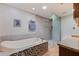 Elegant bathroom featuring a soaking tub with mosaic tile and a walk-in shower at 211 60Th S Ave, St Petersburg, FL 33705