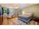 Bright bedroom with parquet flooring, ceiling fan, chair and footstool and large windows at 211 60Th S Ave, St Petersburg, FL 33705
