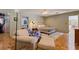 Comfortable bedroom featuring parquet flooring, a seating area and attached bathroom at 211 60Th S Ave, St Petersburg, FL 33705