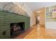 Unique fireplace with decorative artwork and brick hearth, adding character to the living space at 211 60Th S Ave, St Petersburg, FL 33705