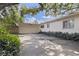 Exterior shot of a home's side entrance and a two-car garage at 211 60Th S Ave, St Petersburg, FL 33705
