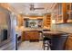 Updated kitchen featuring stainless steel appliances, wooden cabinets, and a cozy breakfast bar at 211 60Th S Ave, St Petersburg, FL 33705