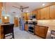 Bright kitchen with stainless steel appliances and wood cabinets at 211 60Th S Ave, St Petersburg, FL 33705