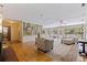 Open living room showcasing hardwood floors, a brick fireplace, and an abundance of natural light at 211 60Th S Ave, St Petersburg, FL 33705