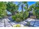 A backyard patio with lush tropical landscaping, a privacy fence, and a covered hot tub at 2201 Horan S Way, Gulfport, FL 33707