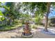 Serene backyard oasis featuring a charming fountain, mature trees, and meticulously maintained landscaping at 2201 Horan S Way, Gulfport, FL 33707