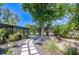 Landscaped backyard features stepping stone walkway, mature trees, fountain, and lush greenery at 2201 Horan S Way, Gulfport, FL 33707