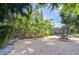 A serene backyard area with attractive fountain, pea gravel ground cover, and mature trees at 2201 Horan S Way, Gulfport, FL 33707