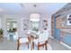 Cozy dining area featuring a round glass table, stylish chairs, and decorative shelving in a naturally lit space at 2201 Horan S Way, Gulfport, FL 33707