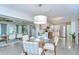 Bright dining area boasts a glass-top table, seating, and a view into the kitchen with stainless steel appliances at 2201 Horan S Way, Gulfport, FL 33707