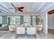 Dining room with a long table with seating, decor and a view to the living room and a door to the patio at 2201 Horan S Way, Gulfport, FL 33707