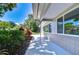 Exterior view of home shows well-manicured lawn, lush landscaping, and white house paint at 2201 Horan S Way, Gulfport, FL 33707