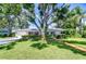Charming single-story home with a lush, well-manicured lawn and mature shade trees enhancing its curb appeal at 2201 Horan S Way, Gulfport, FL 33707