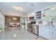 Open-concept kitchen and dining area with stainless steel appliances, white cabinetry, and inviting natural light at 2201 Horan S Way, Gulfport, FL 33707