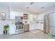 Well-lit kitchen featuring white cabinets, stainless steel appliances, and plenty of counter space at 2201 Horan S Way, Gulfport, FL 33707