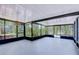 Enclosed lanai features black metal framing, ample sunlight and view of trees and exterior hot tub at 2201 Horan S Way, Gulfport, FL 33707