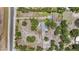 Aerial view of a property with spacious lot, mature trees, RV parking area, and a peaceful setting at 2221 W Lake Dr, Wimauma, FL 33598