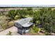 Aerial view of a well-maintained home with a screened porch, fish pond, and lush landscaping at 2221 W Lake Dr, Wimauma, FL 33598