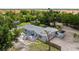 Aerial view showcasing the property with spacious lot, lush greenery, and RV parking area at 2221 W Lake Dr, Wimauma, FL 33598