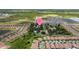 Aerial view showcasing the property's location in a vibrant community, lush landscaping, and serene surroundings at 2221 W Lake Dr, Wimauma, FL 33598