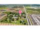 Aerial view showcasing the property in a vibrant community, lush landscaping, and serene surroundings with easy access to roadway at 2221 W Lake Dr, Wimauma, FL 33598