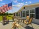 Inviting back deck with outdoor seating, ideal for enjoying the fresh air while overlooking the open backyard and featuring a loyal dog at 2221 W Lake Dr, Wimauma, FL 33598