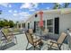 Outdoor deck with ample seating and table, perfect for enjoying outdoor living and entertaining at 2221 W Lake Dr, Wimauma, FL 33598