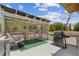 Backyard deck featuring grill, outdoor seating, and decorative privacy lattice at 2221 W Lake Dr, Wimauma, FL 33598