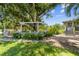 Tranquil backyard featuring a pergola, well-kept greenery, and a brick pathway at 2221 W Lake Dr, Wimauma, FL 33598