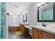 Bright bathroom with tub, dual sinks, and a large mirror at 2221 W Lake Dr, Wimauma, FL 33598