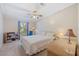 Cozy bedroom features a ceiling fan, ample natural light, and comfortable furnishings at 2221 W Lake Dr, Wimauma, FL 33598