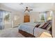 Bright bedroom with large windows, neutral decor, and comfortable furnishings at 2221 W Lake Dr, Wimauma, FL 33598