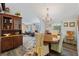 Bright dining area with elegant chandelier, wooden table, and adjacent living space at 2221 W Lake Dr, Wimauma, FL 33598