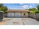 Detached two-car garage with ample parking space and a convenient side entry door at 2221 W Lake Dr, Wimauma, FL 33598