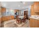 Cozy kitchen with wood cabinets, stainless steel appliances, and a dining area at 2221 W Lake Dr, Wimauma, FL 33598