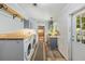 Functional laundry room with washer, dryer, and workspace at 2221 W Lake Dr, Wimauma, FL 33598