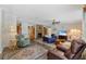 Inviting living room featuring a cozy fireplace, comfortable seating, and natural light at 2221 W Lake Dr, Wimauma, FL 33598