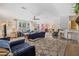Spacious living room with stylish furnishings and an open layout to the dining area at 2221 W Lake Dr, Wimauma, FL 33598
