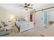 Comfortable main bedroom with ceiling fan, ensuite bathroom, and natural light at 2221 W Lake Dr, Wimauma, FL 33598