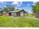 Rustic wooden outbuilding or shed in a spacious backyard setting at 2221 W Lake Dr, Wimauma, FL 33598