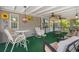 Inviting screened porch with ceiling fans, comfortable seating, and stylish decor for relaxing or entertaining outdoors at 2221 W Lake Dr, Wimauma, FL 33598