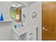 Modern bathroom featuring a round mirror, white vanity, sleek faucet, and tiled walls at 2240 Pinewood Villas Dr, Holiday, FL 34691