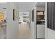 Bright hallway with wood floors leads to an open living space with sliding glass doors and a laundry area at 2240 Pinewood Villas Dr, Holiday, FL 34691