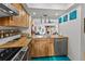 Bright kitchen features custom wood cabinets, stainless steel appliances, and an open view to the living area at 2240 Pinewood Villas Dr, Holiday, FL 34691