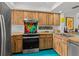 Bright kitchen features custom wood cabinets, stainless steel appliances, and a colorful backsplash at 2240 Pinewood Villas Dr, Holiday, FL 34691
