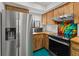 Bright kitchen features custom wood cabinets, stainless steel appliances, and a colorful backsplash at 2240 Pinewood Villas Dr, Holiday, FL 34691