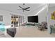 Bright and open living room features modern decor, vaulted ceilings, and sliding glass doors to an outdoor patio at 2240 Pinewood Villas Dr, Holiday, FL 34691